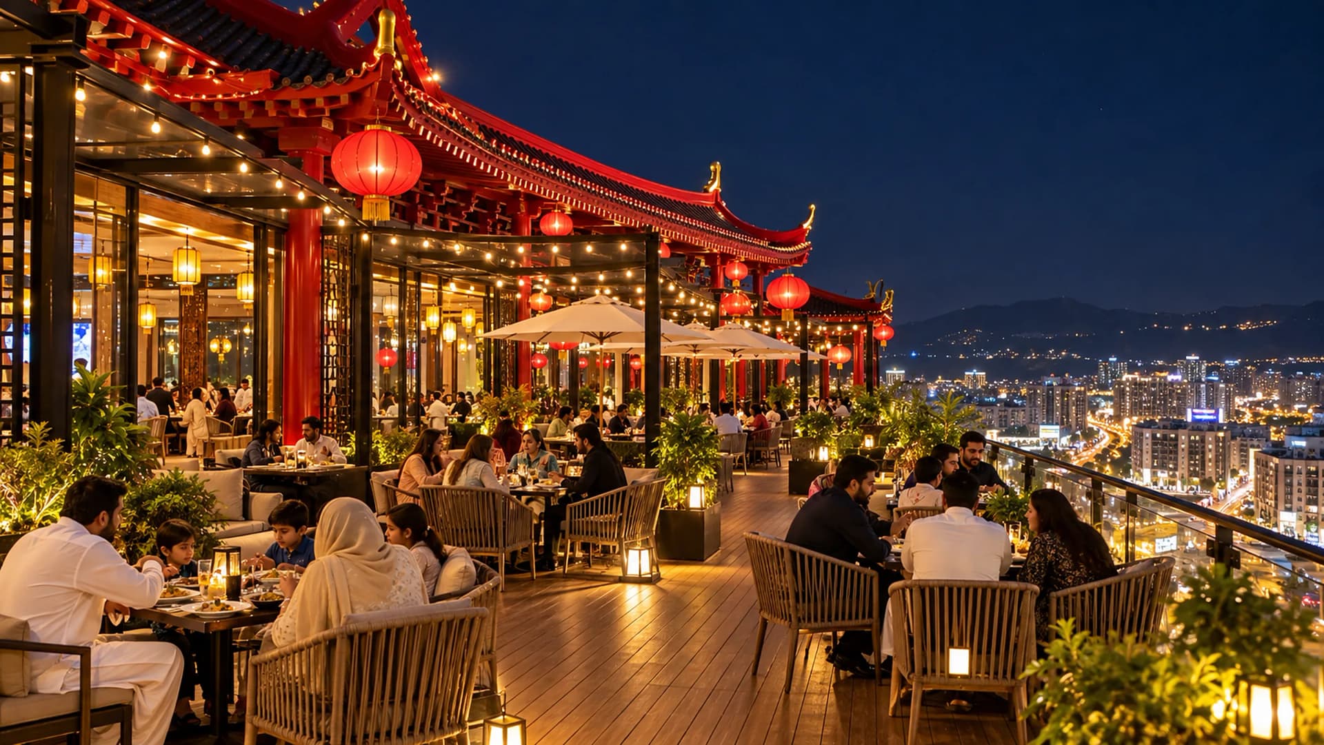 The rooftop dining terrace at night: families at tables under festoon lights and red lanterns, the city lights beyond